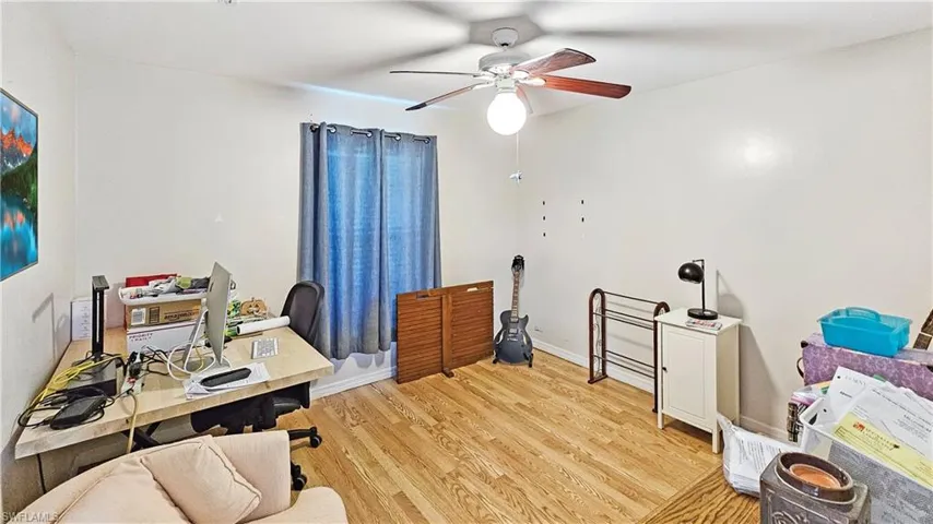 Office area with light hardwood / wood-style flooring and ceiling fan