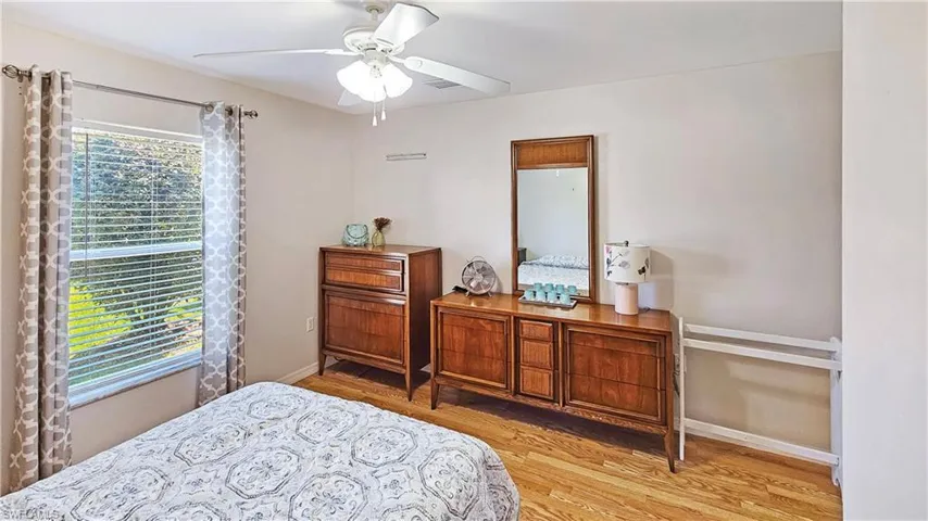 Bedroom featuring ceiling fan and light hardwood / wood-style flooring