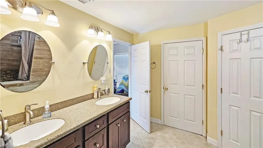 Bathroom featuring tile patterned flooring and vanity