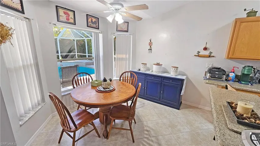 Tiled dining space featuring ceiling fan