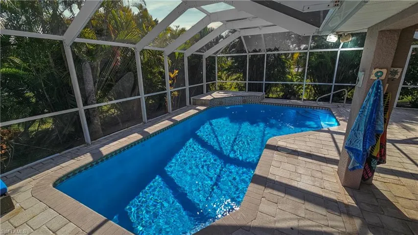 View of pool with a patio and a lanai