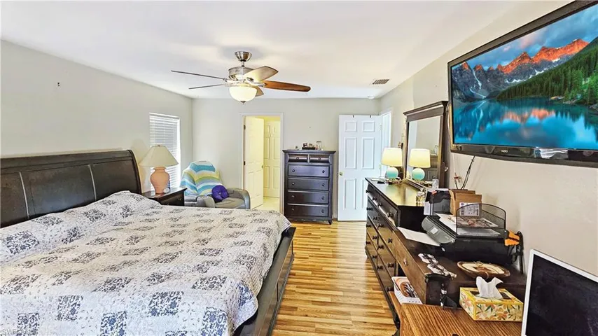 Bedroom featuring ceiling fan and light wood-type flooring