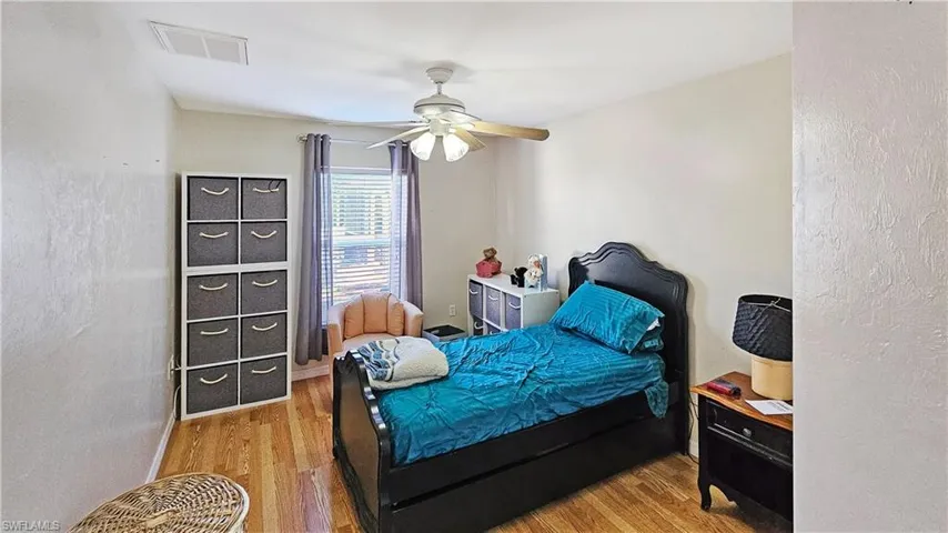 Bedroom featuring wood-type flooring and ceiling fan