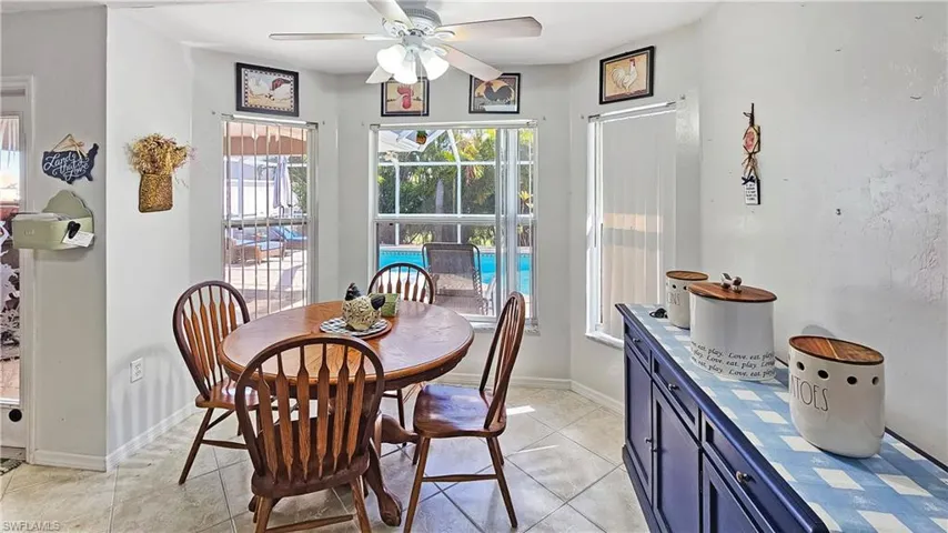 Dining room featuring light tile patterned floors and ceiling fan