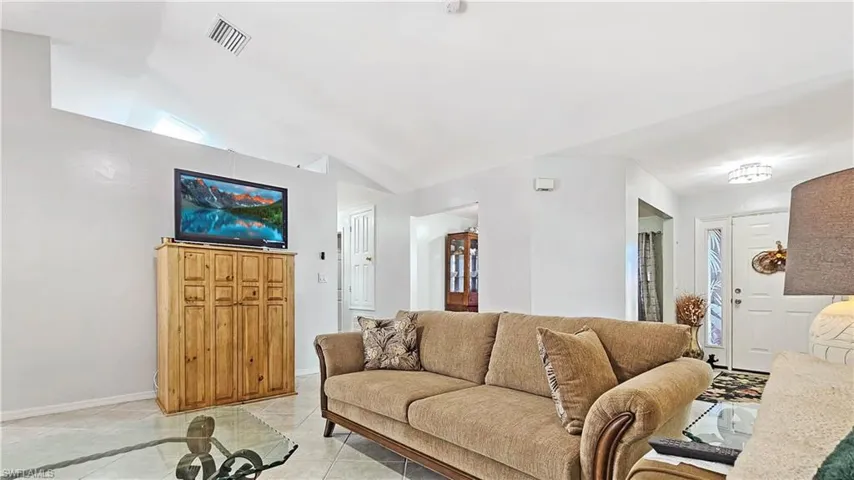 Tiled living room with lofted ceiling