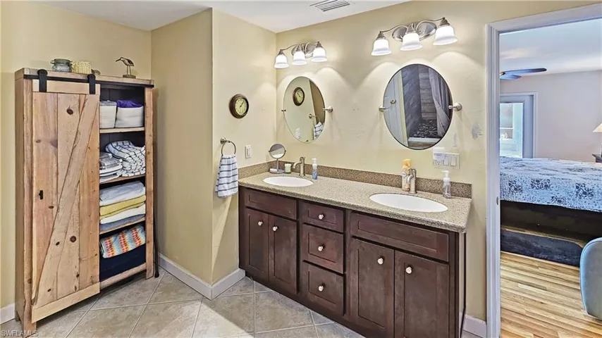 Bathroom with tile patterned floors and vanity