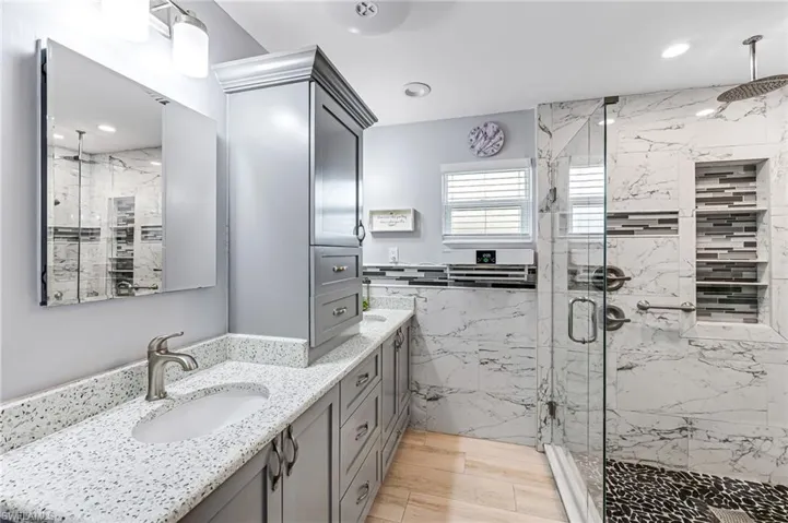 Master en-suite Bathroom with dual vanity , granite countertop, lots of storage, custom cabinets and a shower with glass door