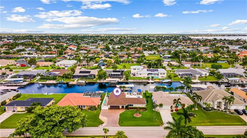 Birds eye view of property with a water view