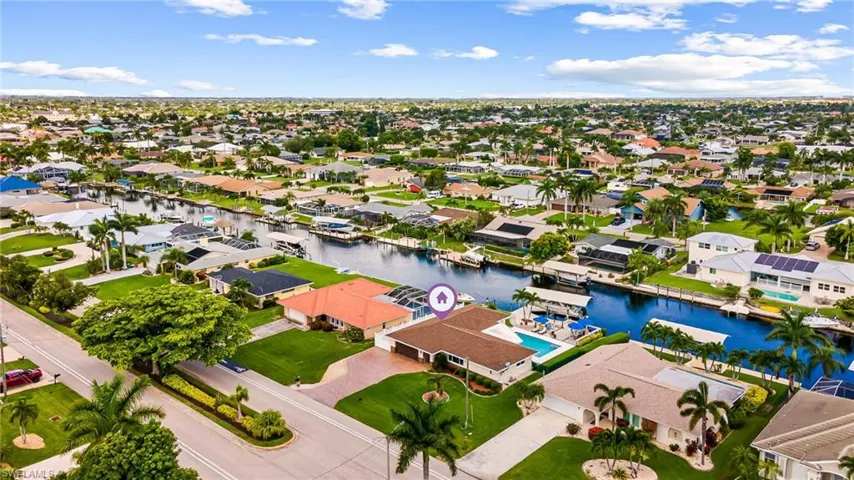 Birds eye view of property with a water view