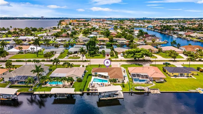 Birds eye view of property with a water view