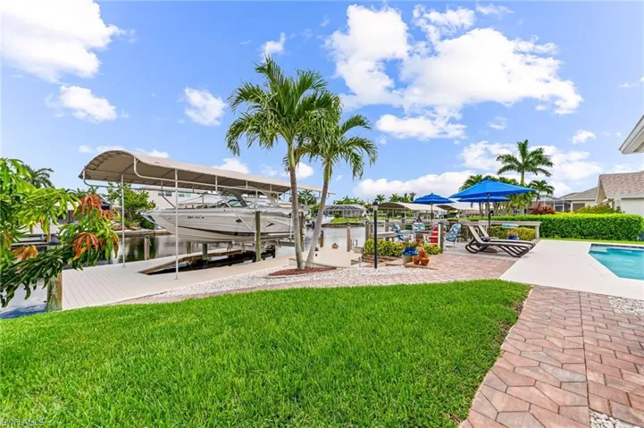 View of yard with a boat dock and a water view