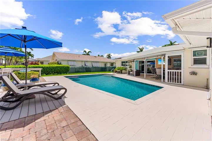 View of swimming pool, pool deck and patio area