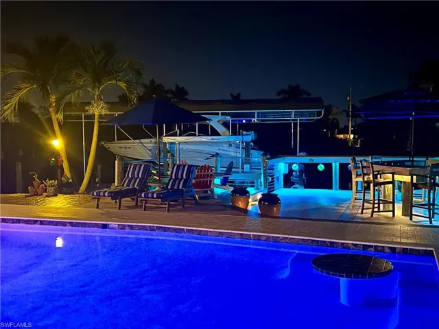 View of pool and deck at night