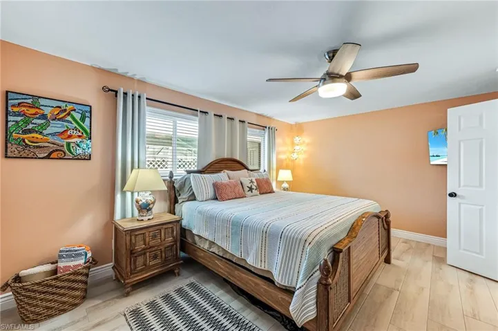 Bedroom with ceiling fan and light tile flooring