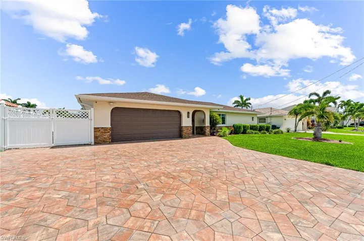 View of front of property with a garage and a front yard