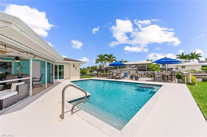 View of pool featuring a patio area and large pool deck