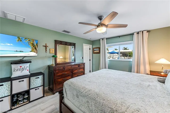 Master bedroom featuring light tile flooring and ceiling fan