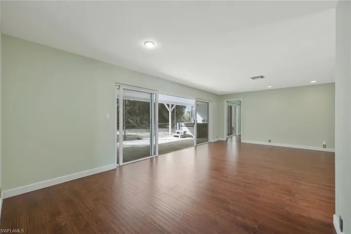 Living room featuring dark wood-style flooring and recessed lighting