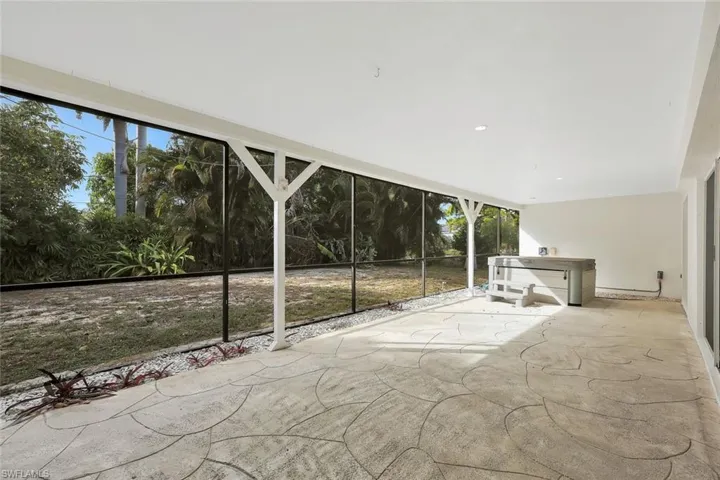 View of patio with a hot tub
