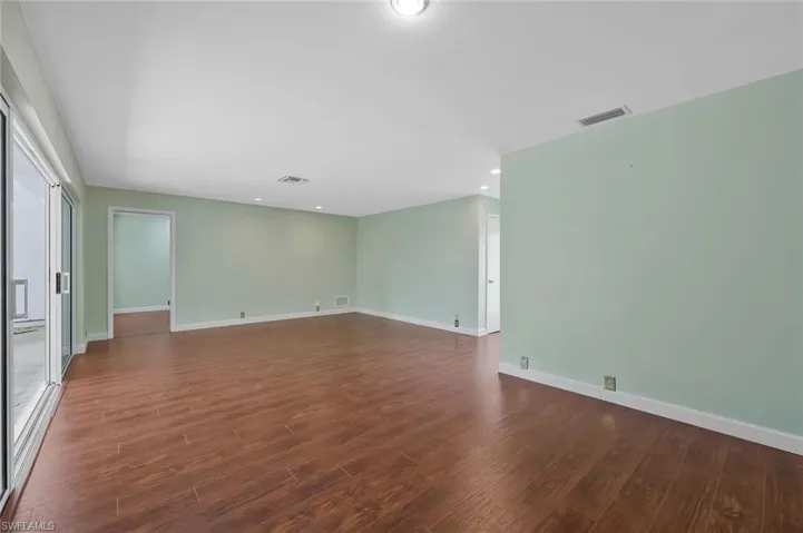 Living  room with dark wood finished floors and recessed lighting