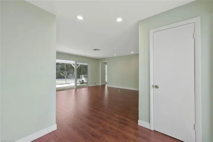 Living room featuring recessed lighting and dark wood-style flooring