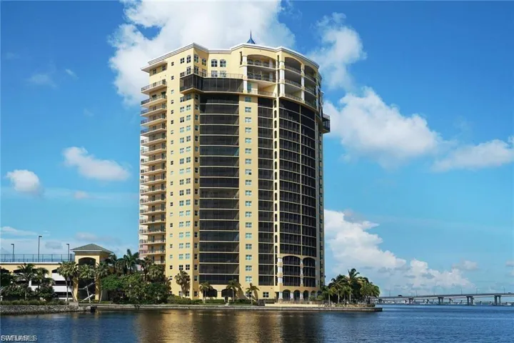 View of apartment building / complex featuring a water view