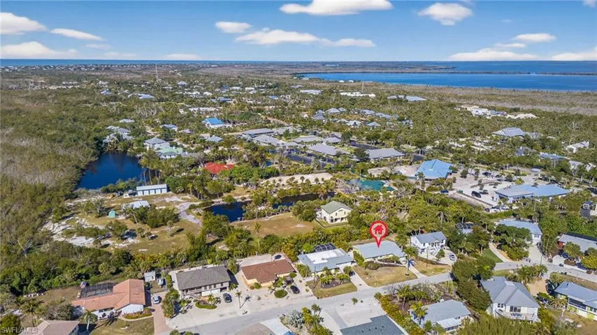 Aerial perspective of suburban area featuring a large body of water