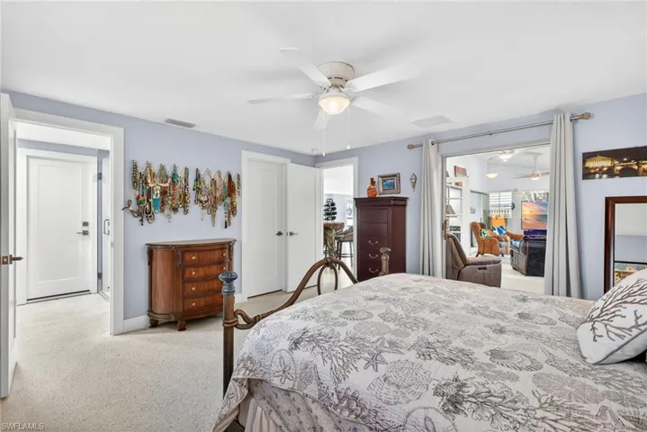 Primary Bedroom featuring a ceiling fan and light carpet