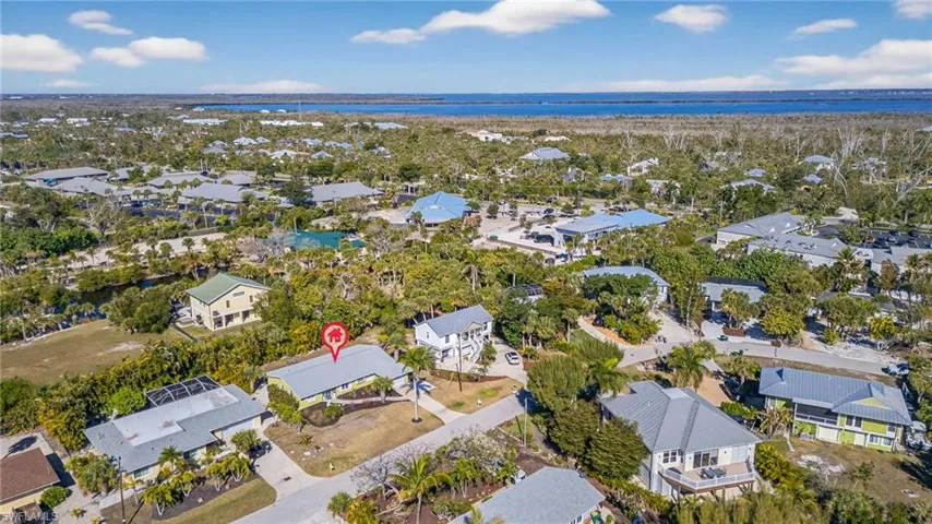 Aerial perspective of suburban area featuring a nearby body of water