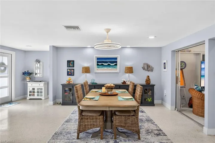 Dining room featuring dark aggregate flooring, recessed lighting, and plenty of natural light