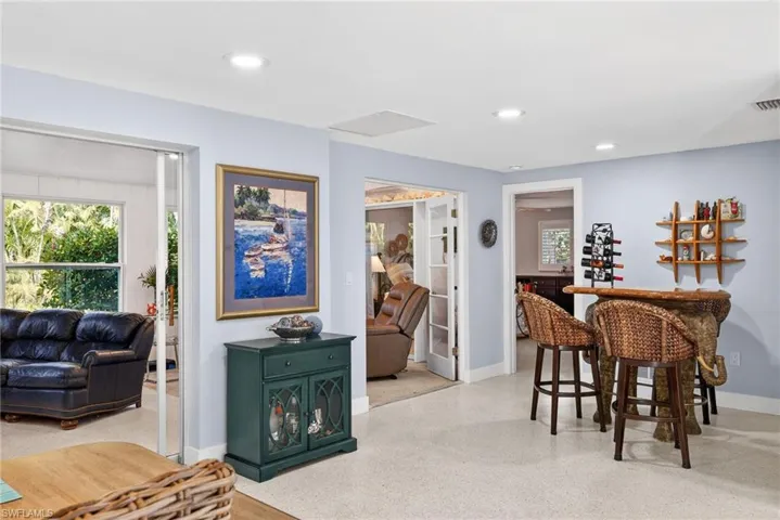 Dining room featuring a dry bar, dark speckled floor, and recessed lighting