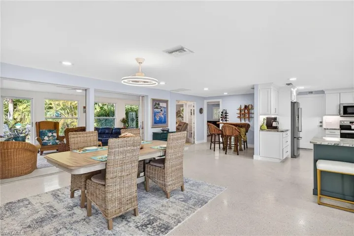 Dining area with dark speckled floor and recessed lighting