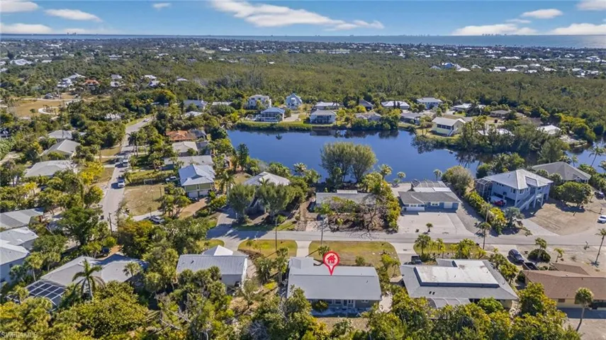 Aerial view of residential area featuring a nearby body of water