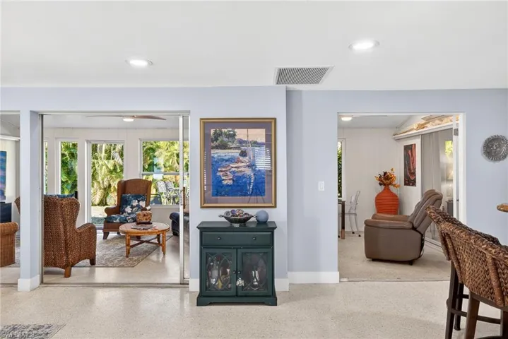 Sitting room featuring speckled floor, recessed lighting, and a ceiling fan