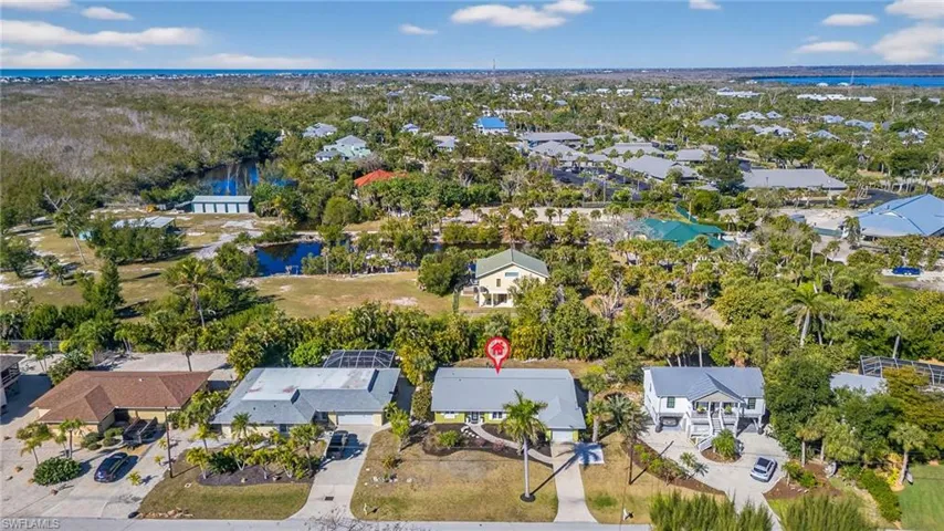 Aerial view of residential area featuring a large body of water