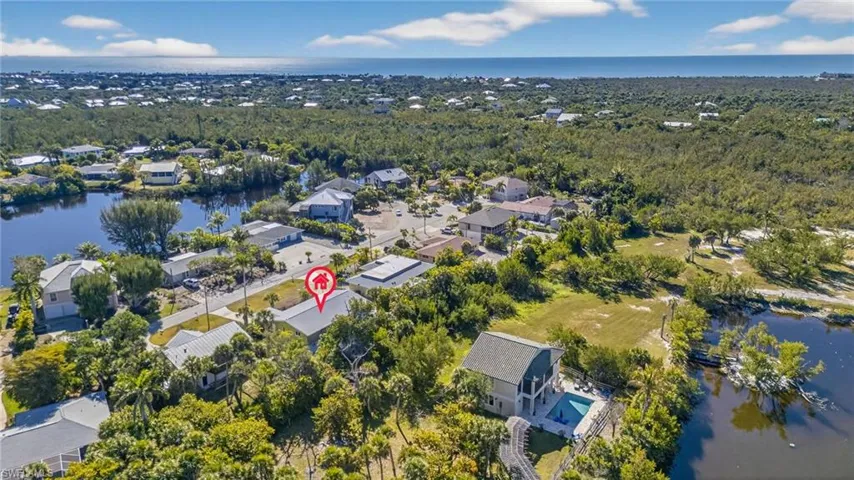 Aerial perspective of suburban area with a nearby body of water