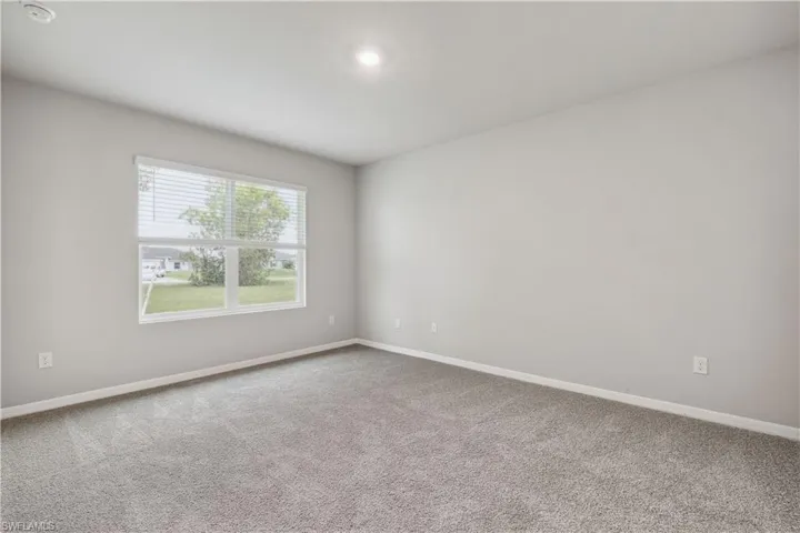 Unfurnished room featuring carpet flooring