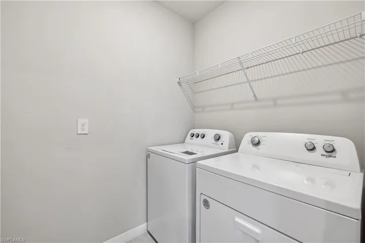 Washroom featuring washing machine and dryer