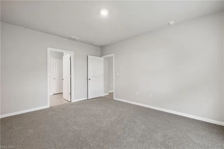 Unfurnished bedroom featuring light carpet