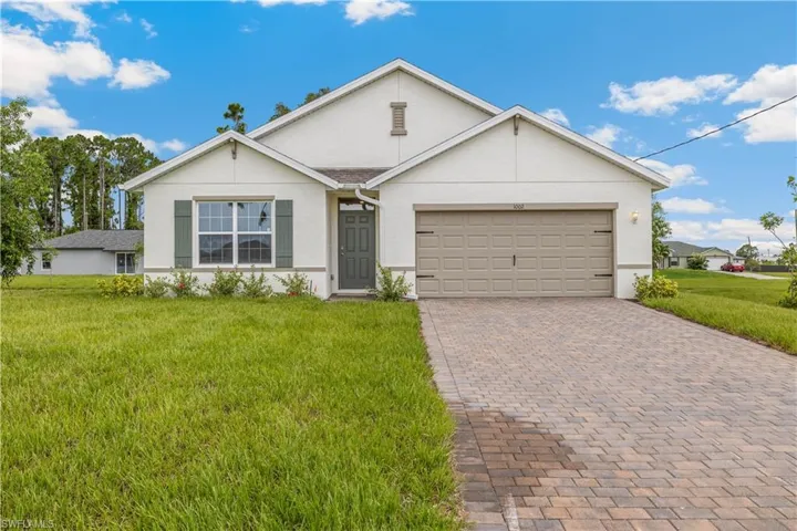 Ranch-style home with a garage and a front yard