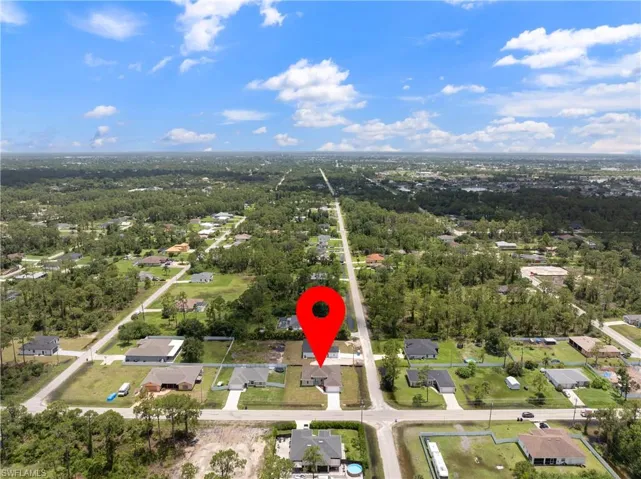 Aerial view of property's location with nearby suburban area