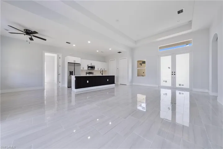 Unfurnished living room with french doors, recessed lighting, and a ceiling fan