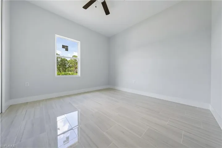 Spare room featuring ceiling fan and light wood-style floors