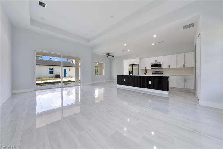 Unfurnished living room featuring recessed lighting and a ceiling fan