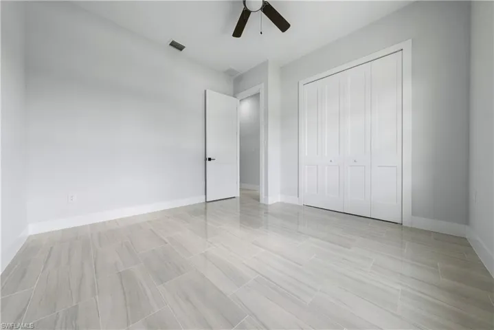 Unfurnished bedroom featuring a closet and ceiling fan
