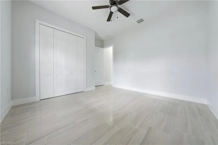 Unfurnished bedroom featuring a closet and a ceiling fan