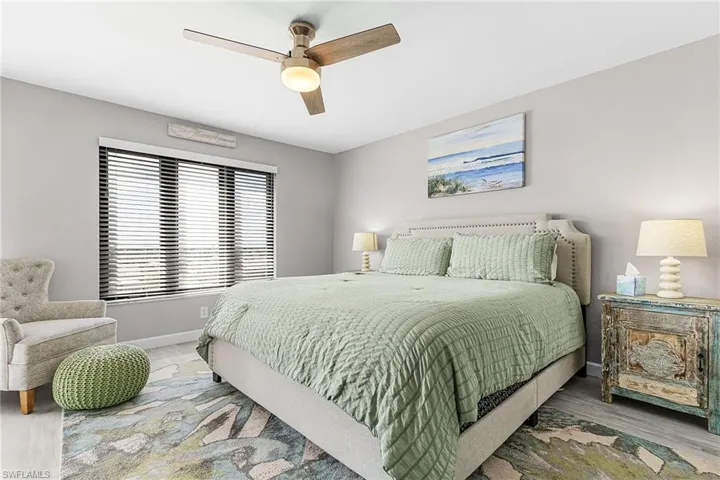 Bedroom with a ceiling fan and wood finished floors