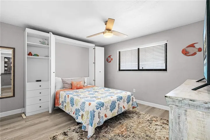 Bedroom with light wood finished floors and ceiling fan