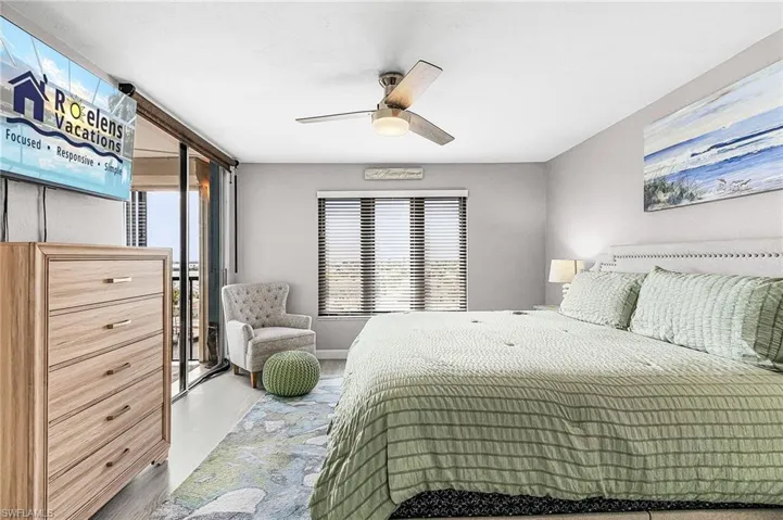 Bedroom with access to exterior, ceiling fan, and wood finished floors