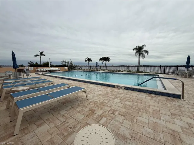 Community pool with a patio